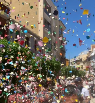 Lluvia de confeti de colores durante la cercavila de las fiestas mayores de Mollet del Vallès con público celebrando en la calle