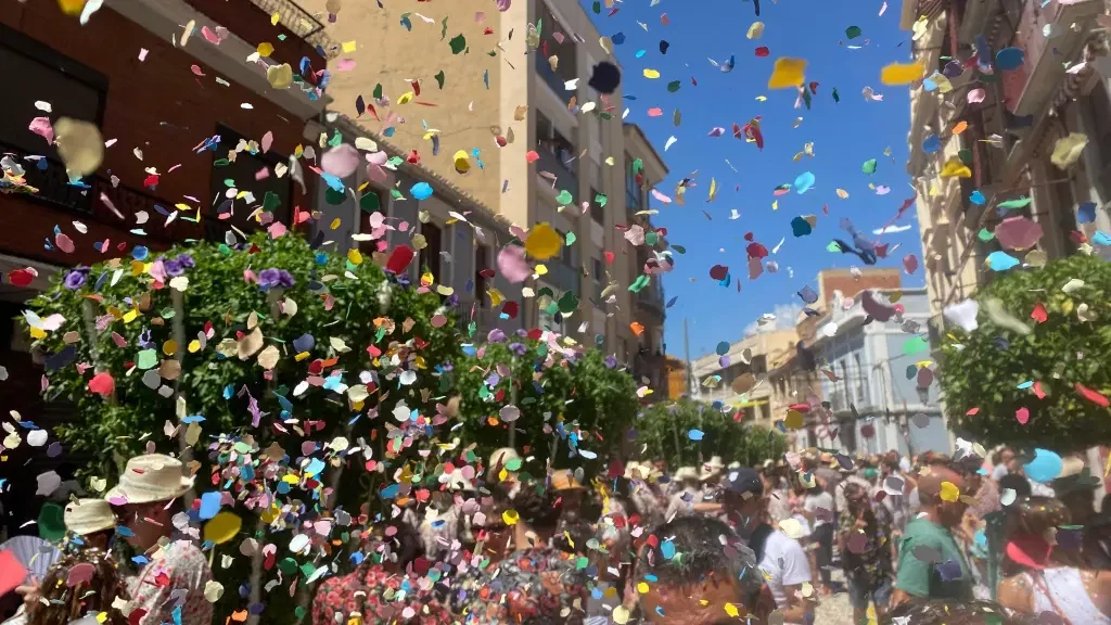 Lluvia de confeti de colores durante la cercavila de las fiestas mayores de Mollet del Vallès con público celebrando en la calle